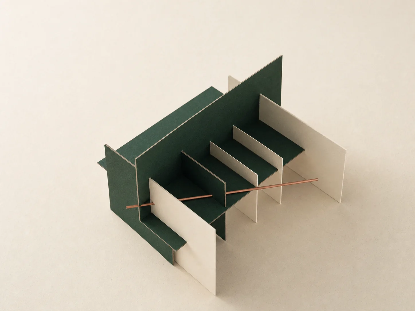 Interlocking geometric paper and timber forms precisely joined in cream, green and copper